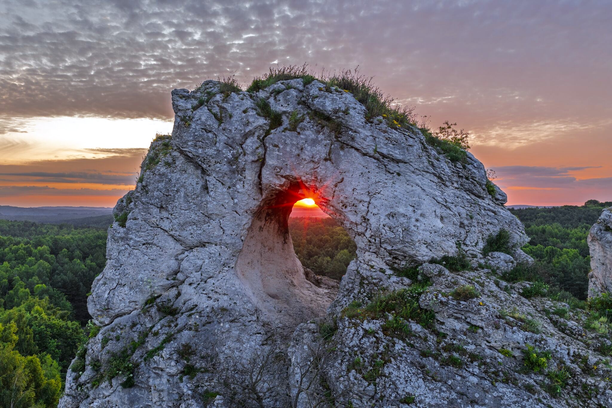 Aerial photograph of a rock arch at sunset