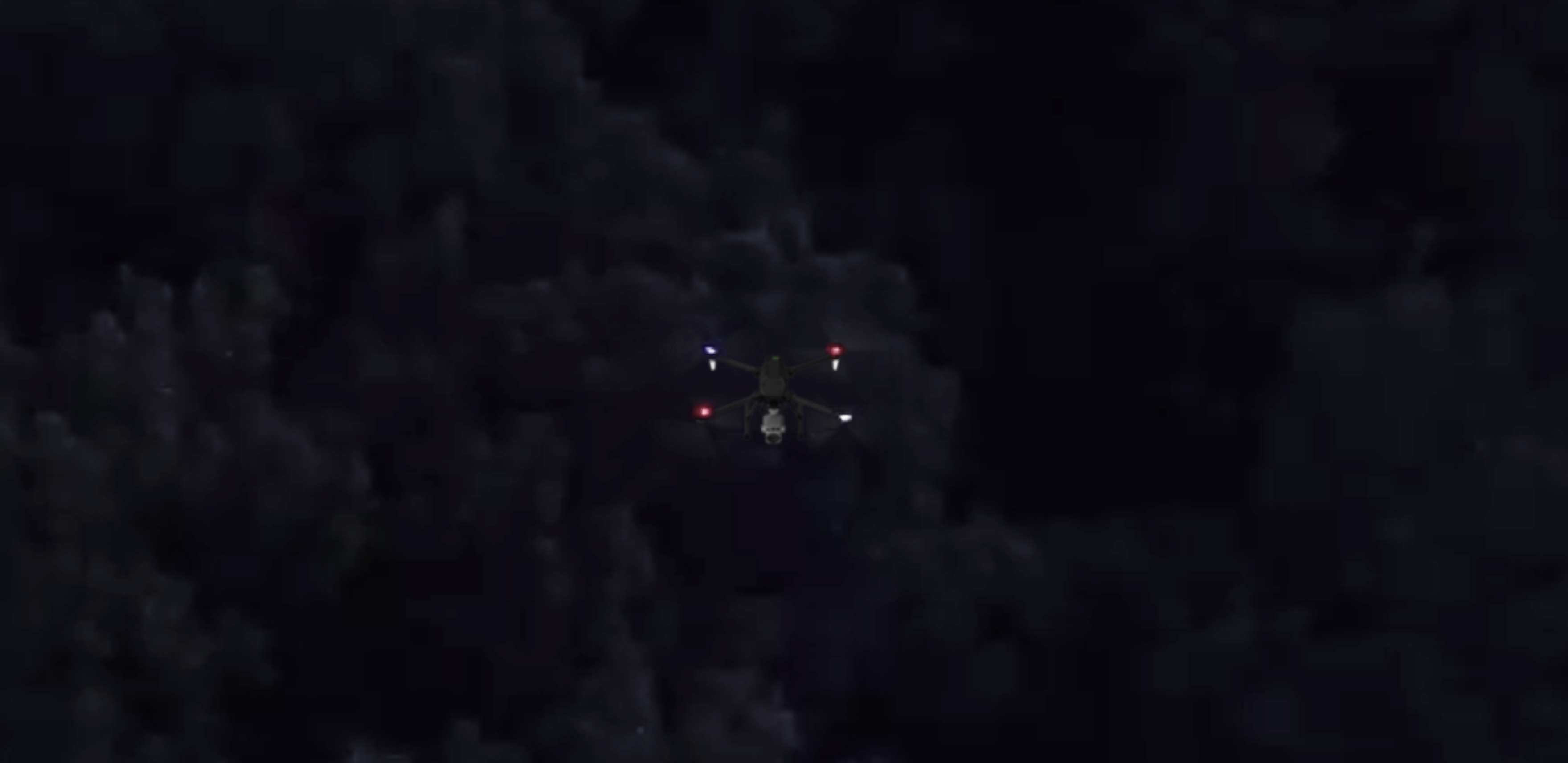 Drone flying at night with navigation lights