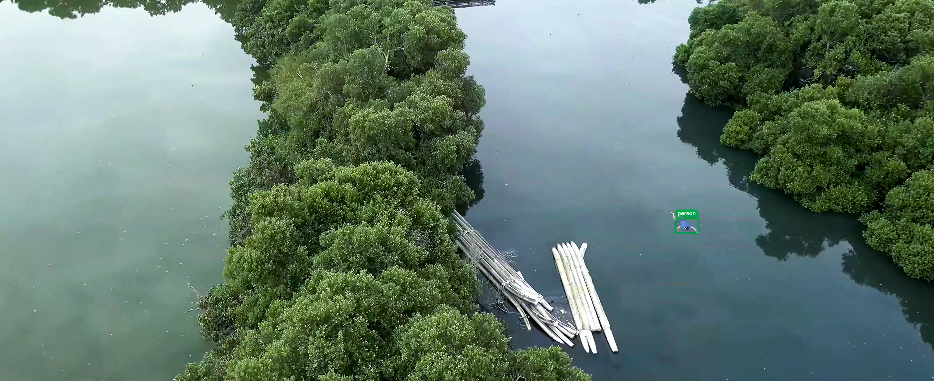 Aerial view of a water search operation along a riverbank