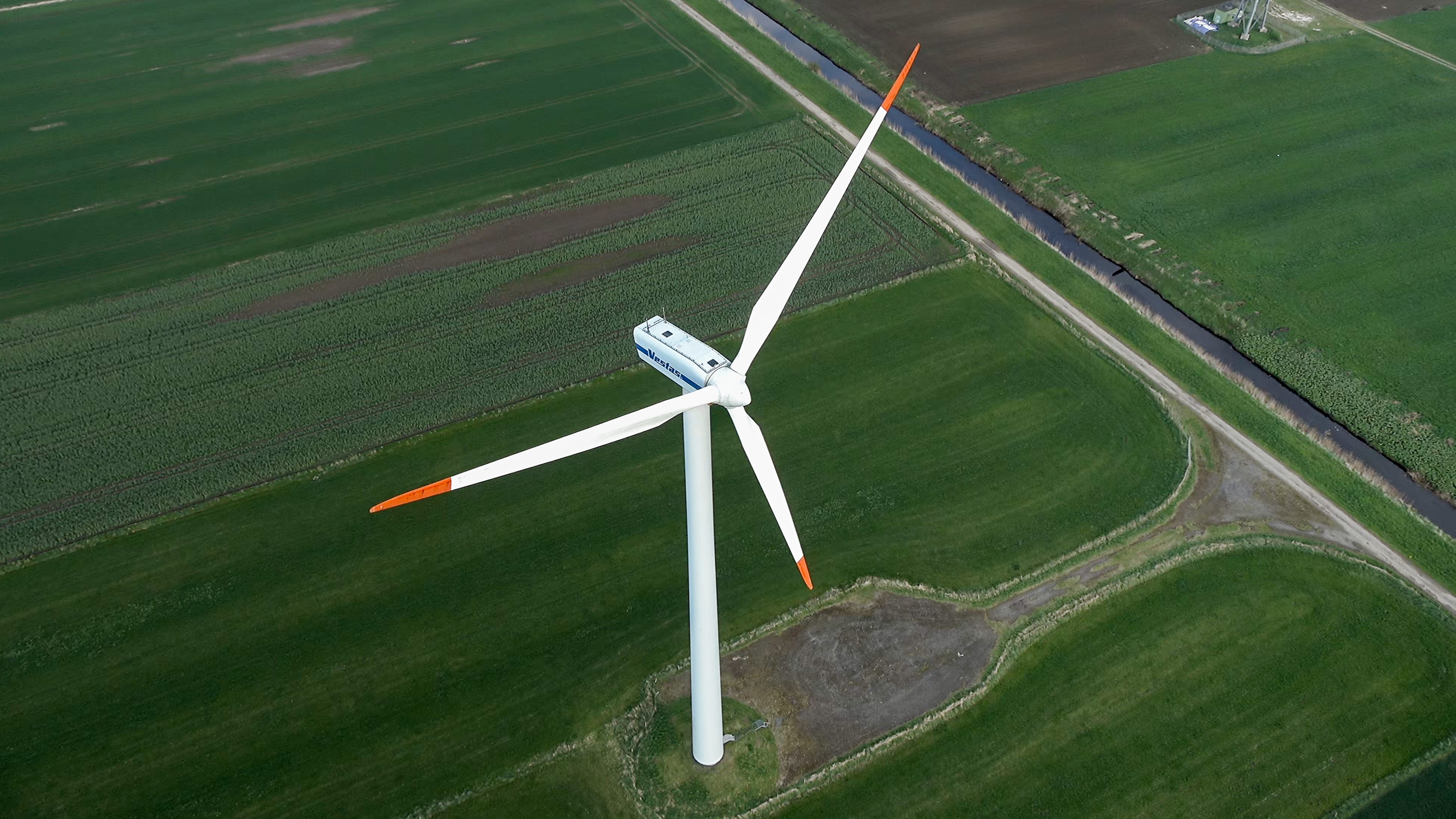 Aerial view of a wind turbine with AI detection inset